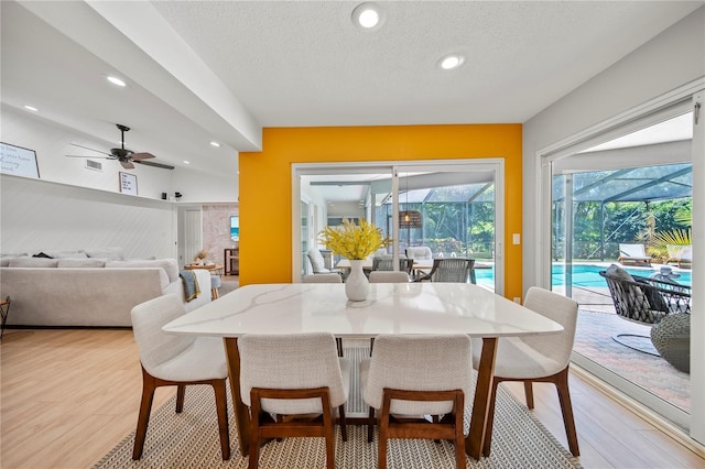 1810 Pine Hill Dr, Safety Harbor, FL 34695 - dining space with a sunroom, a ceiling fan, light wood-style floors, recessed lighting, and a textured ceiling