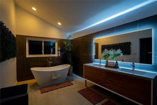 1810 Pine Hill Dr, Safety Harbor, FL 34695 - full bathroom featuring tile walls, a freestanding tub, lofted ceiling, double vanity, and recessed lighting