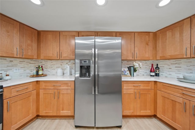 1810 Pine Hill Dr, Safety Harbor, FL 34695 - kitchen featuring stainless steel refrigerator with ice dispenser, light countertops, backsplash, and light wood finished floors