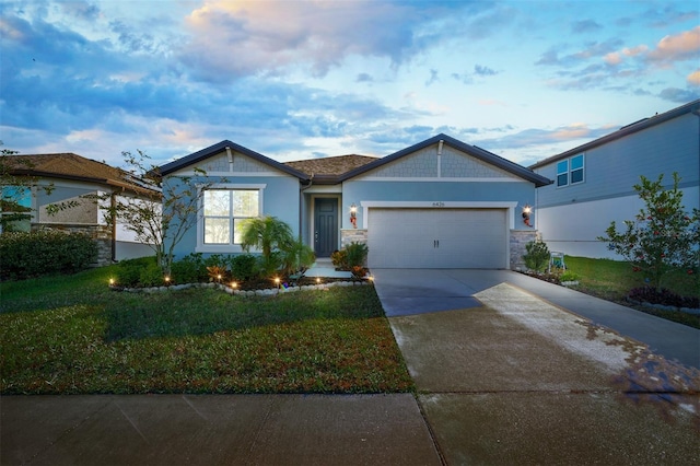 6426 Bradford Woods Dr, Zephyrhills, FL 33542 - view of front of property featuring stone siding, concrete driveway, a front lawn, and an attached garage
