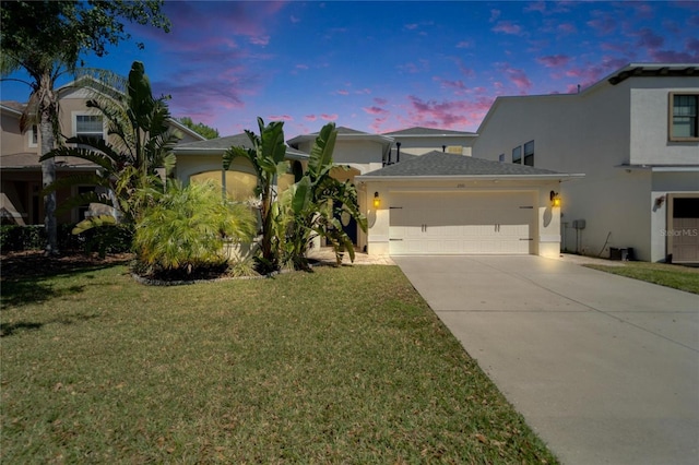 2510 Cross More St, Valrico, FL 33594 - view of front of home with an attached garage, stucco siding, a front yard, and concrete driveway