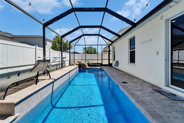 2510 Cross More St, Valrico, FL 33594 - view of swimming pool with glass enclosure, a patio, a fenced in pool, and a fenced backyard