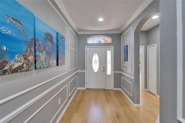 2510 Cross More St, Valrico, FL 33594 - entrance foyer featuring arched walkways, ornamental molding, a decorative wall, and light wood-style flooring