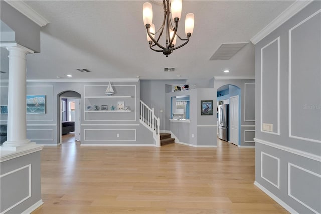 2510 Cross More St, Valrico, FL 33594 - entryway with ornamental molding, light wood finished floors, a chandelier, and visible vents