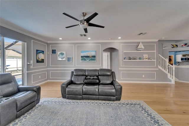2510 Cross More St, Valrico, FL 33594 - living area with wood finished floors, crown molding, a decorative wall, and visible vents