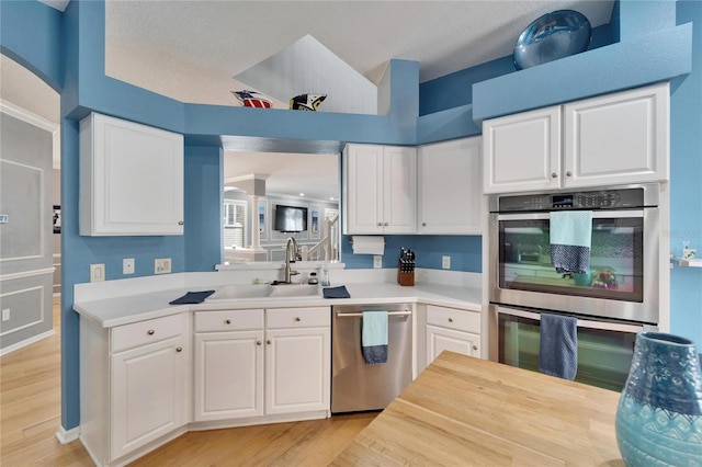 2510 Cross More St, Valrico, FL 33594 - kitchen with light wood-type flooring, a sink, white cabinetry, and stainless steel appliances