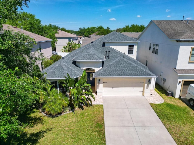 2510 Cross More St, Valrico, FL 33594 - view of front of property with a garage, a front yard, a shingled roof, and driveway