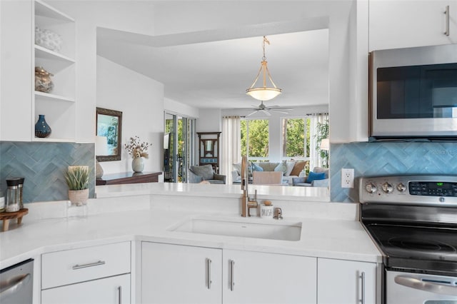 kitchen featuring stainless steel appliances, light countertops, and a sink