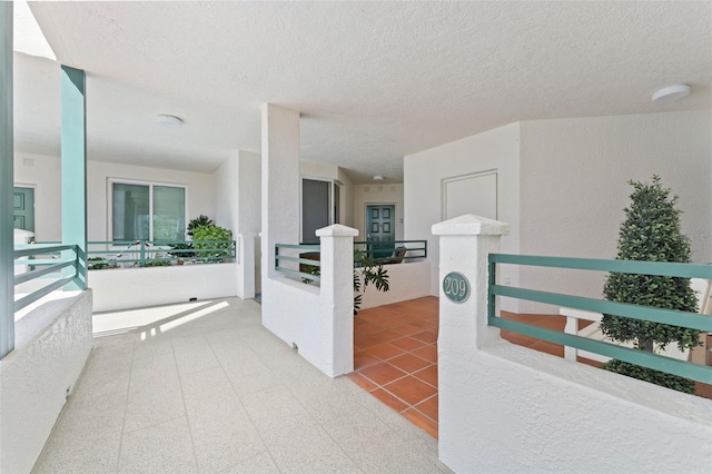 4750 Dolphin Cay Ln S Unit 209, Saint Petersburg, FL 33711 - hallway with a textured ceiling and an upstairs landing