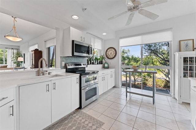 4750 Dolphin Cay Ln S Unit 209, Saint Petersburg, FL 33711 - kitchen with stainless steel appliances, light countertops, recessed lighting, light tile patterned floors, and backsplash