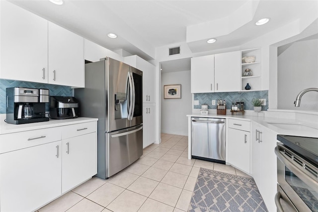 4750 Dolphin Cay Ln S Unit 209, Saint Petersburg, FL 33711 - kitchen featuring appliances with stainless steel finishes, recessed lighting, backsplash, light countertops, and open shelves