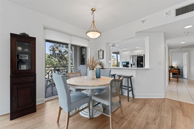 4750 Dolphin Cay Ln S Unit 209, Saint Petersburg, FL 33711 - dining room featuring light wood-type flooring and ceiling fan