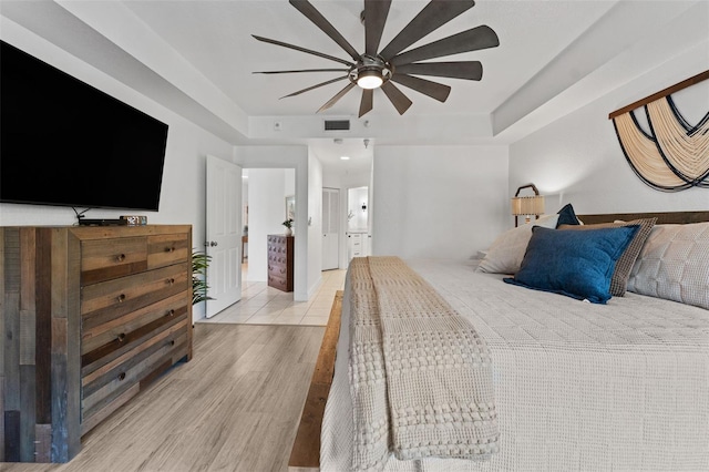 4750 Dolphin Cay Ln S Unit 209, Saint Petersburg, FL 33711 - bedroom with light wood-style flooring and a ceiling fan