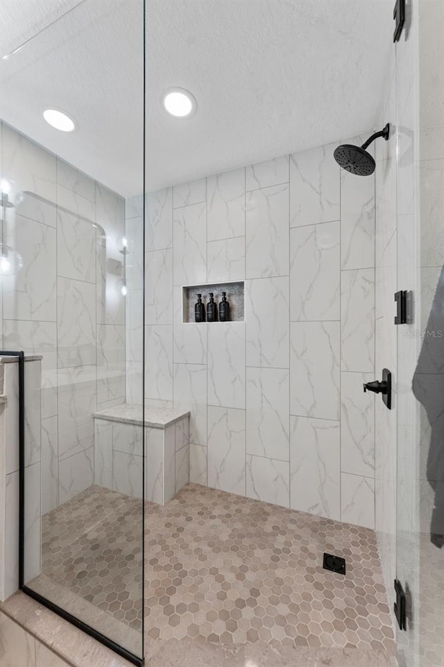 4750 Dolphin Cay Ln S Unit 209, Saint Petersburg, FL 33711 - bathroom featuring tiled shower, a textured ceiling, and recessed lighting