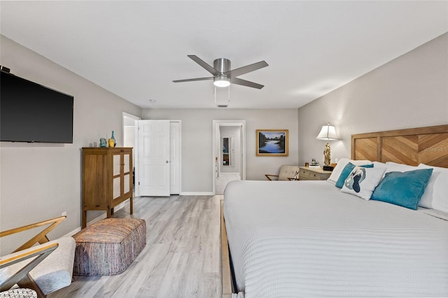 bedroom featuring baseboards, a ceiling fan, and light wood-style flooring