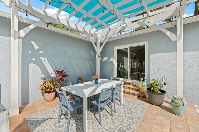 view of patio with outdoor dining area and a pergola