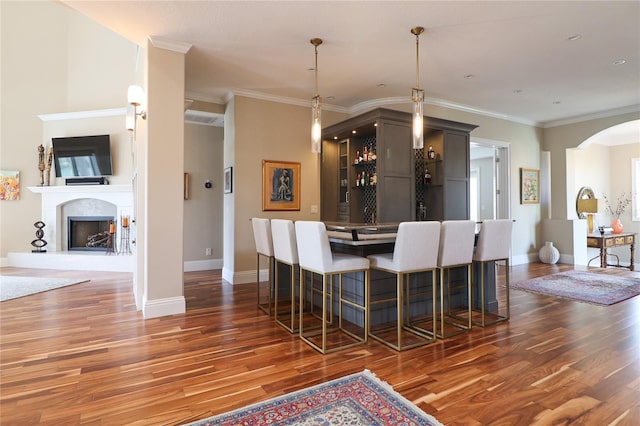 11105 5th St E, Treasure Island, FL 33706 - dining area with arched walkways, baseboards, and wood finished floors