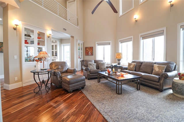 11105 5th St E, Treasure Island, FL 33706 - living room featuring dark wood finished floors, a towering ceiling, baseboards, visible vents, and ceiling fan