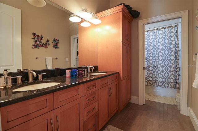 11105 5th St E, Treasure Island, FL 33706 - full bathroom with a shower with shower curtain, wood finished floors, and a sink