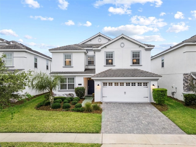 1568 Maidstone Ct, Davenport, FL 33896 - traditional home featuring decorative driveway, a tile roof, stucco siding, and a front lawn