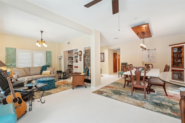 living room with ceiling fan with notable chandelier and visible vents