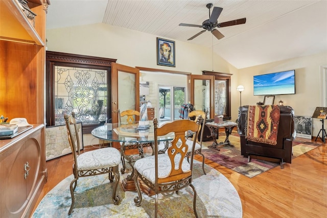dining room with vaulted ceiling, wood finished floors, and ceiling fan