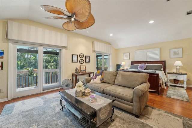 bedroom featuring vaulted ceiling, wood finished floors, and access to outside