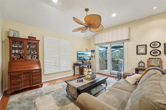 living room featuring a ceiling fan, wood finished floors, lofted ceiling, baseboards, and recessed lighting