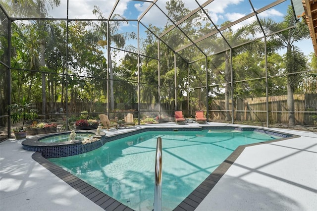 view of pool with a fenced backyard, a pool with connected hot tub, a lanai, and a patio area
