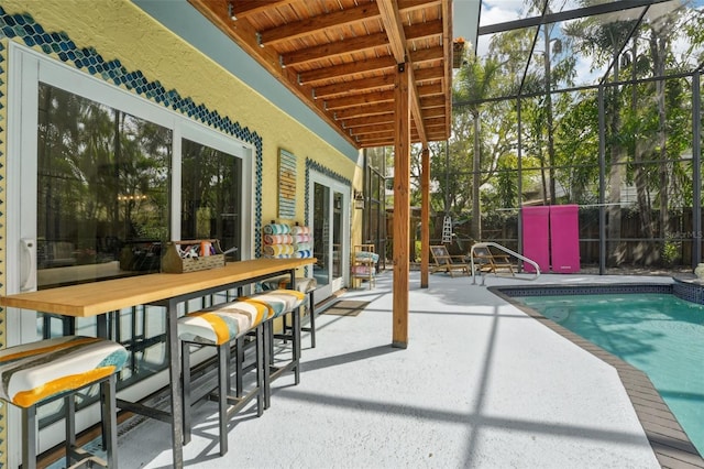 outdoor pool featuring a patio, fence, and a lanai