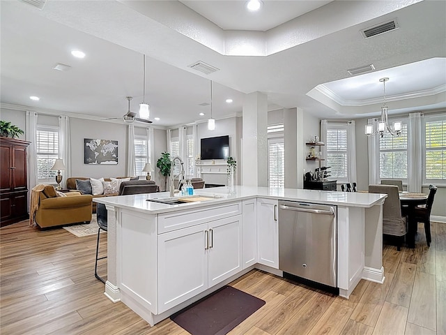 kitchen with open floor plan, visible vents, dishwasher, and a sink