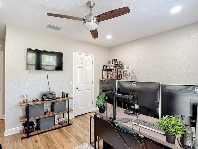 office area featuring recessed lighting, light wood-type flooring, baseboards, visible vents, and a ceiling fan