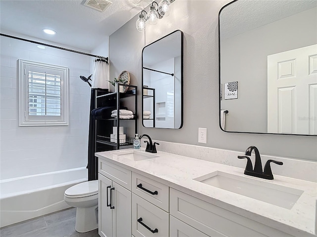 bathroom with visible vents, shower / tub combo, toilet, and a sink