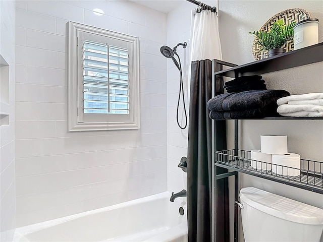 bathroom with shower / tub combo and toilet