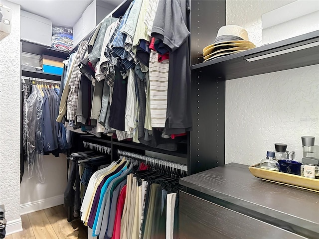 walk in closet featuring wood finished floors