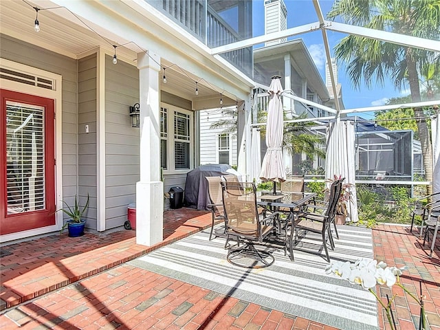 view of patio / terrace with outdoor dining space, a grill, and a lanai