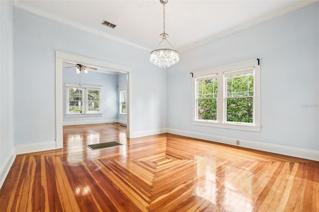 515 Frank Lloyd Wright Way, Lakeland, FL 33803 - empty room featuring plenty of natural light, ornamental molding, a chandelier, baseboards, and wood finished floors