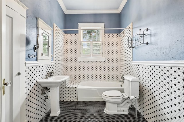 515 Frank Lloyd Wright Way, Lakeland, FL 33803 - bathroom with toilet, tub / shower combination, tile walls, tile patterned floors, and crown molding