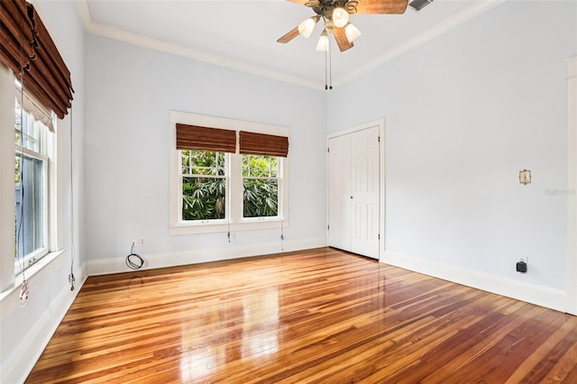 515 Frank Lloyd Wright Way, Lakeland, FL 33803 - spare room with healthy amount of natural light, crown molding, wood finished floors, a ceiling fan, and baseboards