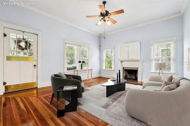 515 Frank Lloyd Wright Way, Lakeland, FL 33803 - living room featuring wood finished floors, ceiling fan, a high end fireplace, crown molding, and baseboards