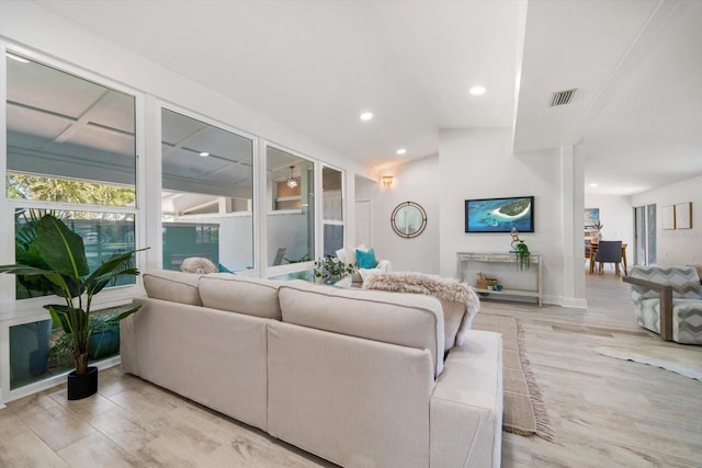 living room with visible vents, recessed lighting, and light wood-type flooring