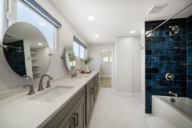 full bathroom featuring a sink, double vanity, tub / shower combination, and visible vents