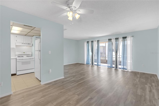 unfurnished living room with a textured ceiling, a ceiling fan, light wood-style flooring, and baseboards