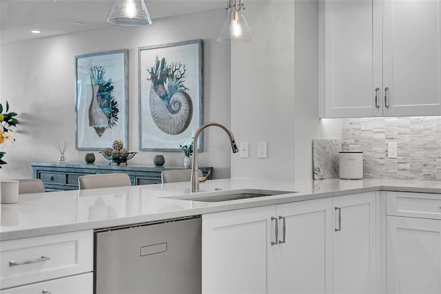 kitchen featuring light countertops, a sink, tasteful backsplash, white cabinetry, and dishwasher