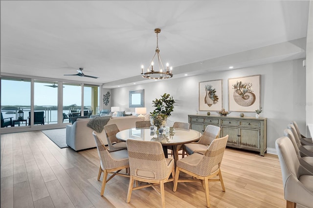 dining space featuring recessed lighting, light wood-style floors, and ceiling fan with notable chandelier
