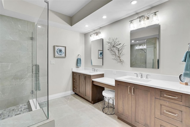 bathroom featuring marble finish floor, a sink, recessed lighting, and a stall shower