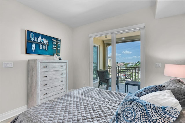bedroom with baseboards and access to outside