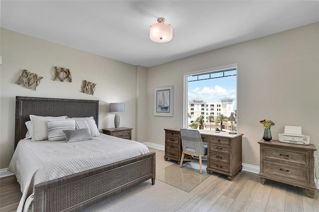 bedroom featuring baseboards and light wood-style floors