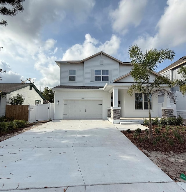 5011 21st Ave N, Saint Petersburg, FL 33710 - view of front facade featuring a garage, driveway, a porch, and stucco siding
