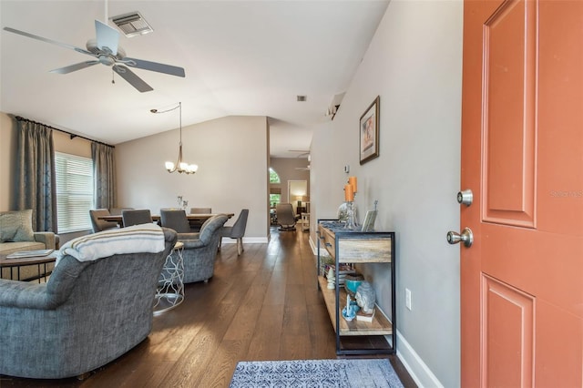 1187 Mistwood Dr, Tarpon Springs, FL 34688 - living room with dark wood-style floors, vaulted ceiling, visible vents, and ceiling fan with notable chandelier